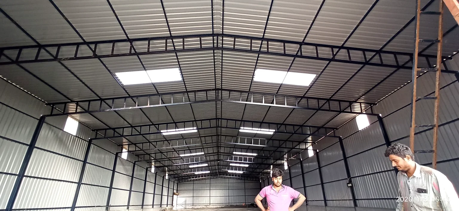 Completed warehouse shed interior with roof skylights and steel cladding.