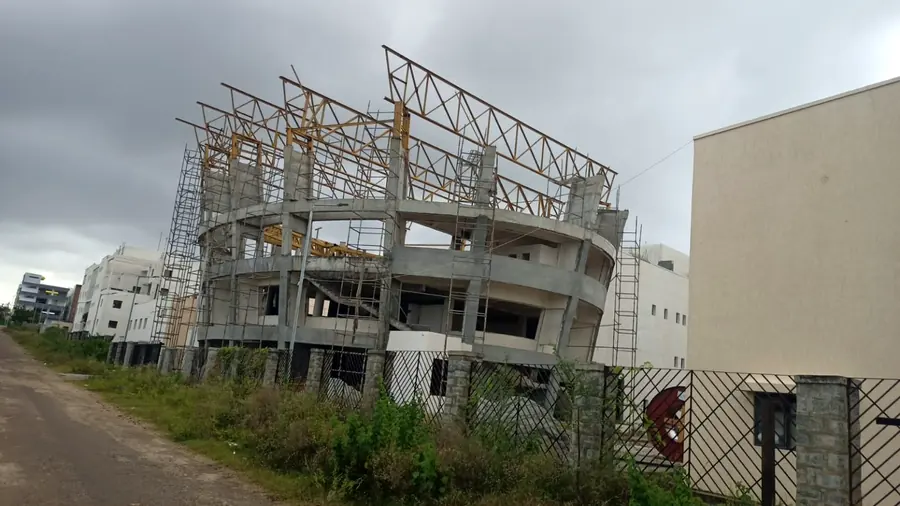 Steel roof truss extension installed over a multi-storey concrete building.