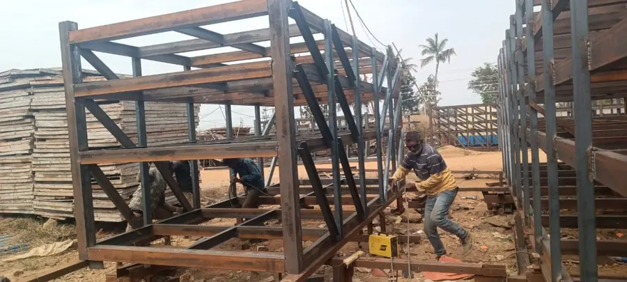 Steel frame modules being fabricated and welded in a fabrication yard.
