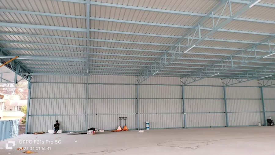 Completed warehouse interior with steel columns, roof trusses and cladding.