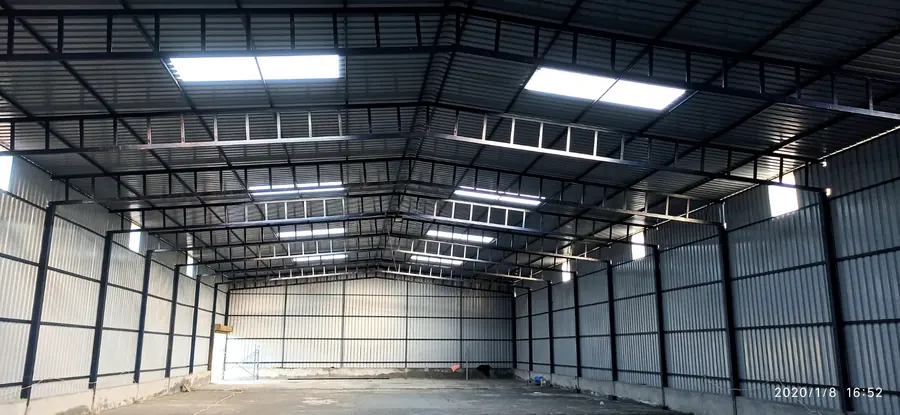 Completed steel shed interior with metal roofing and side cladding.