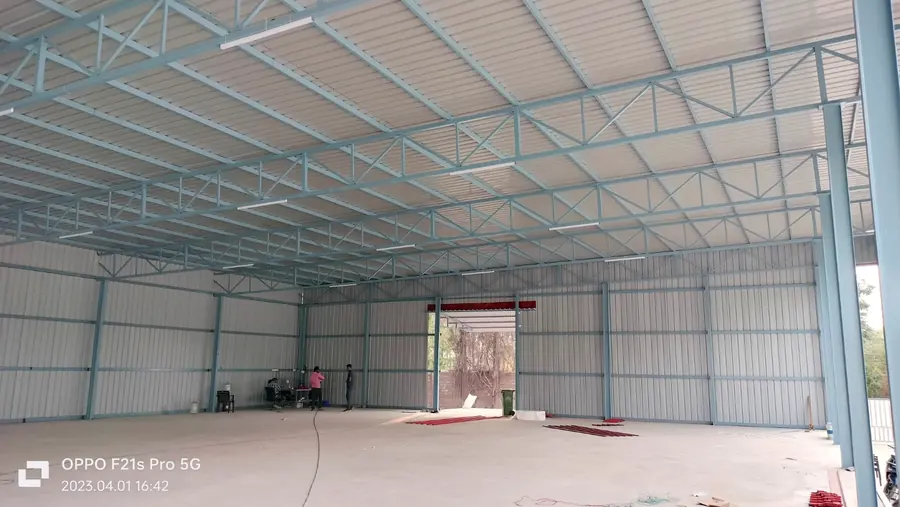 Completed industrial shed interior with finished roofing and wall cladding.